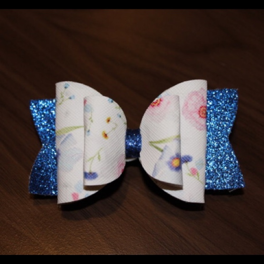 Double layer floral bow with navy sparkle tail!